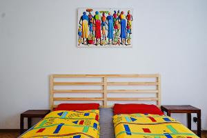 a bedroom with two beds and a painting on the wall at Ristorante Locanda Zott in Valle Onsernone in Vergeletto +29 photos