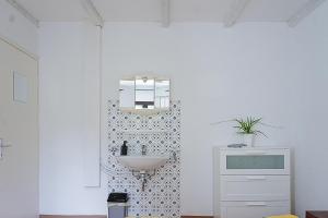a bathroom with a sink and a white wall at Ristorante Locanda Zott in Valle Onsernone in Vergeletto