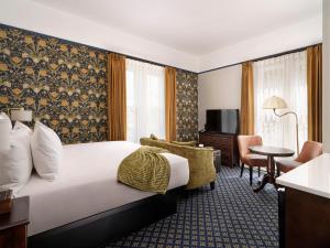 a hotel room with a bed and a desk at Pendray Inn and Tea House in Victoria