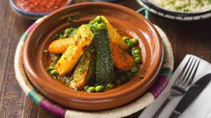 a bowl of food with carrots and peas on a table at Gîte d'étape Imane Café ET Restaurant in Aït Amar +57 photos