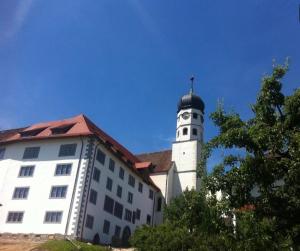 a building with a clock tower on top of it at Mini Apartment in Öhningen