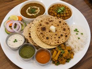 a plate of food with rice and different types of food at Younis Guest house in Srinagar +13 photos
