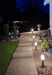 a pathway with lights in a garden at night at Hochsalerblick in Laufenburg
