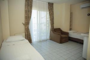 a room with a bed and a chair and a window at Life Apart in Marmaris +20 photos