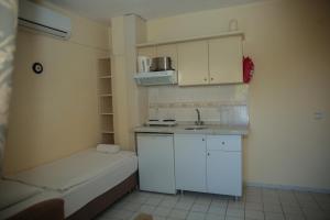 a small kitchen with white cabinets and a sink at Life Apart in Marmaris