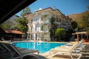 a hotel with a swimming pool in front of a building at Life Apart in Marmaris