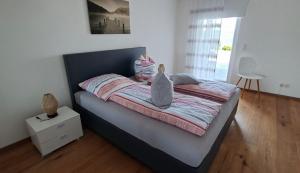 a bedroom with a bed with two cats sitting on it at Hochsalerblick in Laufenburg