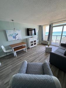a living room with a couch and a table at Boardwalk Beach Resort in Myrtle Beach
