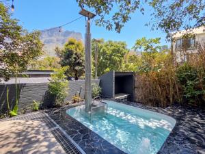 a swimming pool in the backyard of a house at Lily of the Valley - Higgovale in Cape Town