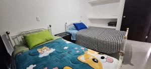 a small bedroom with a bed with a cow blanket at Casa Las Luces in Nanacamilpa