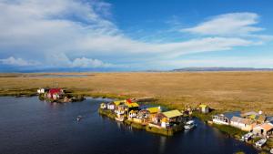 an aerial view of a small village in the water at KAY PACHA LODGE Uros in Puno