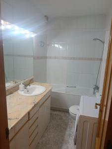 a bathroom with a sink and a tub and a toilet at APARTAMENTO QUINTO in Valderrobres +12 photos