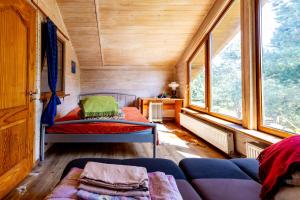 a small room with a couch and a bed in a train at Green park residence in Tīnūži