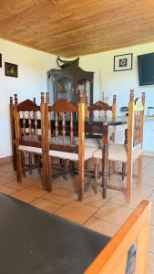 a dining room with a wooden table and chairs at Valle Sereno, Hospedaje rural cerca del Salto del Buey in Abejorral +28 photos