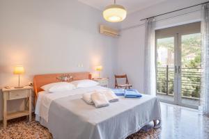 a bedroom with a bed with two towels on it at Giorgos House in Nafpaktos