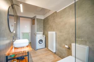 a bathroom with a sink and a washing machine at Giorgos House in Nafpaktos +38 photos