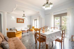 a living room with a table and chairs and a couch at Giorgos House in Nafpaktos