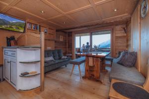a living room with a couch and a table in a cabin at Familienwanderhof Eggeler in Liesing