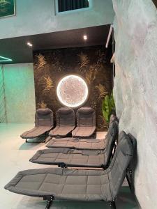 a row of chairs in a room with a wall at Vila Elezi 2 in Tirana