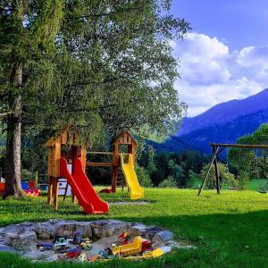 a park with a playground with a slide and a playintend at Stanglhof - by myNests in Bad Aussee