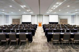 a large room with rows of tables and chairs at Holiday Inn - Cincinnati - Liberty Way by IHG in West Chester +47 photos