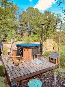 a wooden deck with a grill on it at Cabane Kota Désiré, bain nordique in Saint Die +16 photos