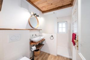 a bathroom with a sink and a mirror at Stanglhof - by myNests in Bad Aussee +156 photos