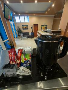 a kitchen counter with a pot on top of a stove at Albatros 2 Family Hotel in Kiten