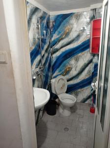 a bathroom with a toilet and a sink at Апартамент in Razgrad
