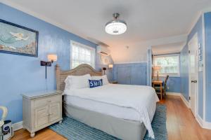 a blue bedroom with a bed and a table at Andros Suite in Key West +30 photos