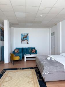 a bedroom with a bed and a blue couch at Hostel Nikšić in Nikšić +21 photos