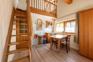 a kitchen and dining room with a staircase and a table at Pension MÜLLER - ehemals Pension Wenger in Kirchheim im Innkreis