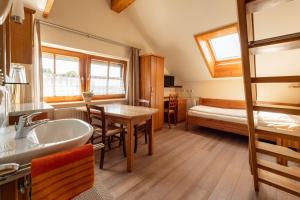 a bathroom with a sink and a bedroom with a bed at Pension MÜLLER - ehemals Pension Wenger in Kirchheim im Innkreis +14 photos