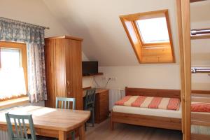 a bedroom with a table and a bed and a desk at Pension MÜLLER - ehemals Pension Wenger in Kirchheim im Innkreis