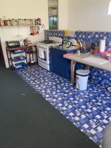 a kitchen with a blue and white tiled floor at Playa El Obispo B La Marea building La Libertad in La Libertad +10 photos