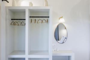 a white bathroom with a mirror and a sink at Villa Aerys in Skopelos Town +86 photos