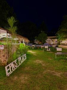 a park with benches in the grass at night at Epa's Place in Awoyaya