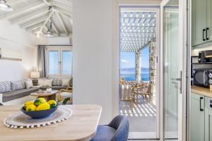 a kitchen and living room with a view of the ocean at Villa Aerys in Skopelos Town
