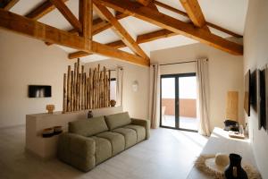 a living room with a couch and a large window at Casamore in Meria