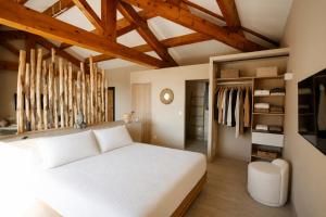 a bedroom with a white bed and wooden ceilings at Casamore in Meria