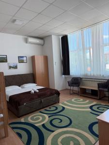 a hotel room with a bed and a carpet at Hostel Nikšić in Nikšić