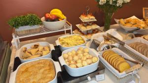 a buffet with many different types of bread and food at Hotel Melo in Balneário Camboriú
