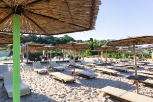 a beach with a bunch of chairs and umbrellas at Horizon 180 in Varna City