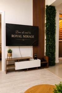 a living room with a tv on a wall at ROYAL MIRAGE Militari Residence in Chiajna