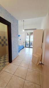 a hallway with a door and a chair in a room at Hotel Alba Chiara Sant'Andrea Salento in SantʼAndrea +148 photos