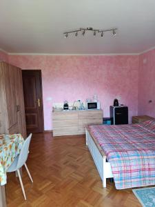 a bedroom with two beds and a dresser in it at Locazione breve LE ROSE in Darfo