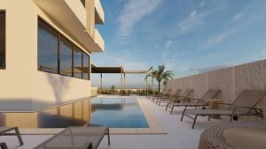 a resort with a swimming pool and lounge chairs at AViSOS HOTEL & APARTMENTS in Marmaris