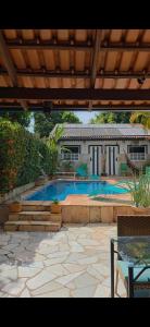 a swimming pool in a yard with a house at Pousada jade in Pirenópolis +16 photos