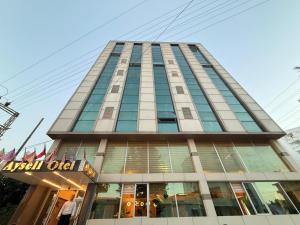 a tall building with a sign in front of it at Ayseli Hotel in Mersin