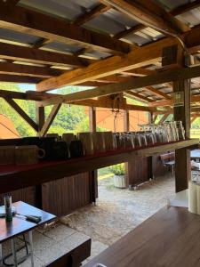 a row of pots sitting on a wooden shelf at Green River - robinzonski kamp in Duga Resa